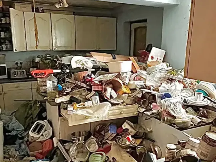 Before kitchen clearance showing a dirty kitchen filled with waste, clutter and unwanted items