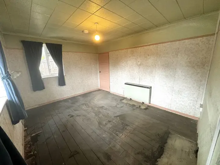After house clearance showing the lounge completely cleared back to bare flooring and empty usable space
